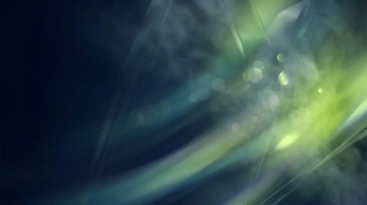 Abstract green and blue light streaks on a dark background